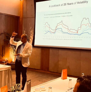 Rohit Bhayana presents a 25-year market volatility chart at the Private Compass event.