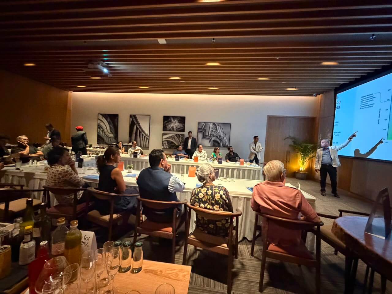 Attendees listen as a speaker presents at the Private Compass event