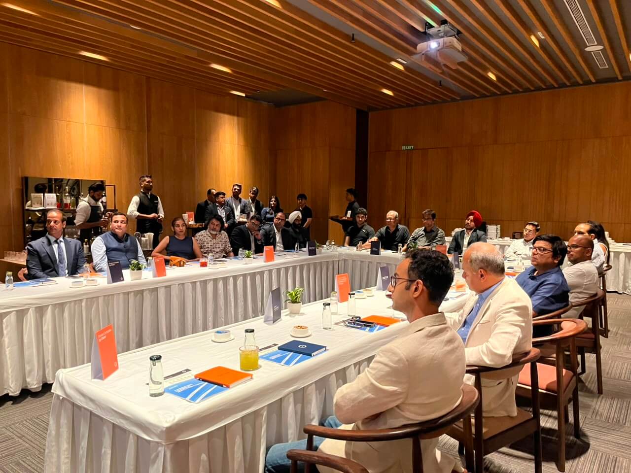 Attendees seated at long tables during the Private Compass event by Oister.