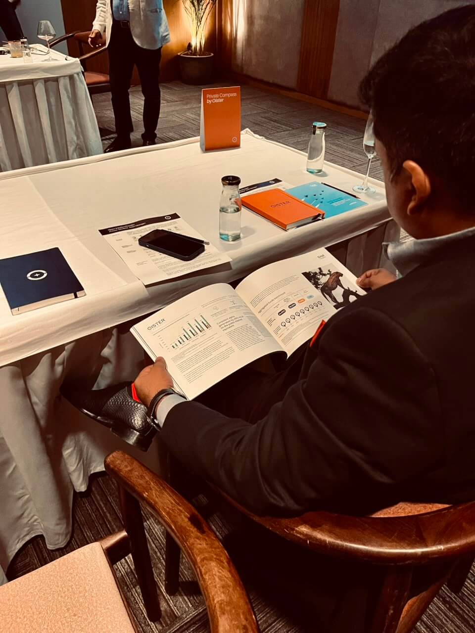 An attendee reviews charts in the Oister report at Private Compass.